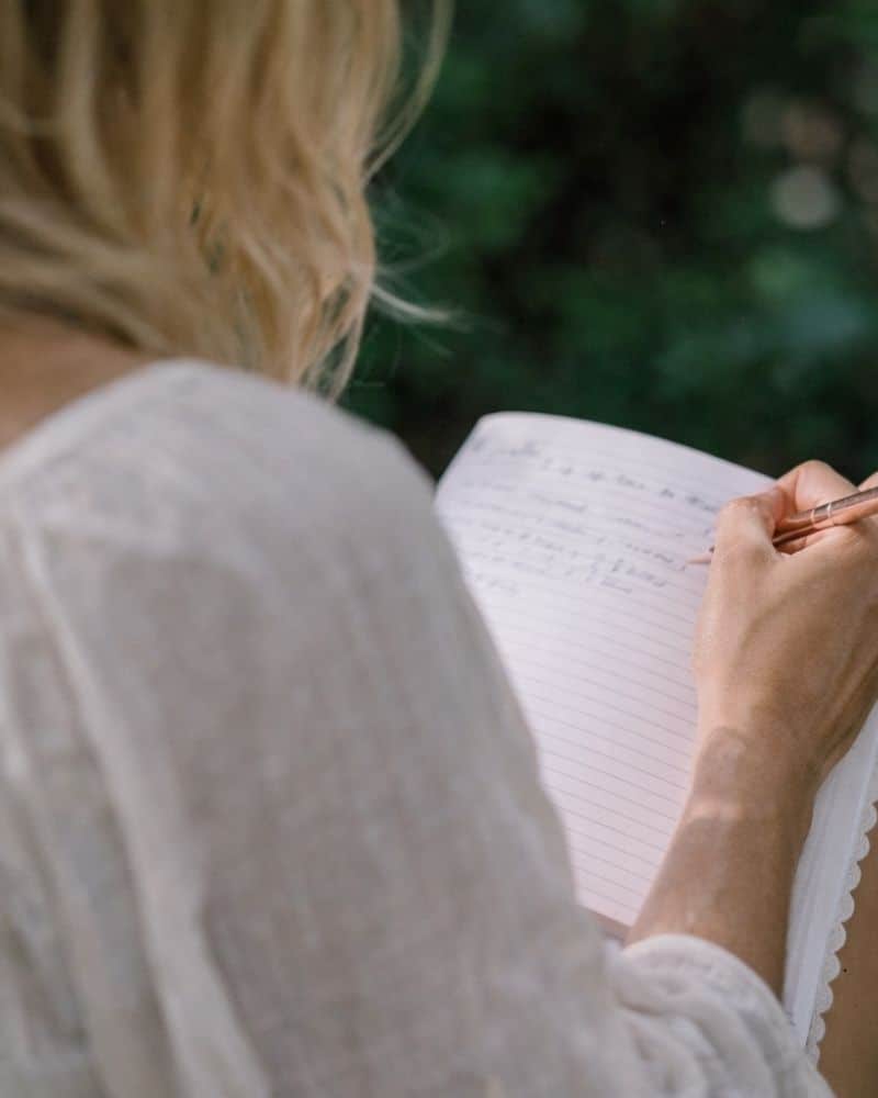 The Belonging - a 2-day self-love retreat in Hampshire. Woman journaling her reflections