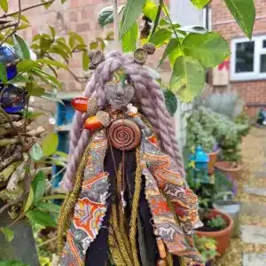 Oakenwyrd spirit doll placed on a woodland altar beside candles and oak bark — pagan altar decor handcrafted for grounding, ancestral healing, and new moon ritual.