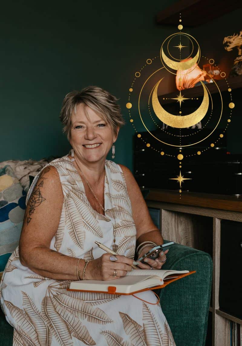 Tania Meacher smiling while seated with a notebook and phone, with a gold crescent moon design overlaid on the photograph.