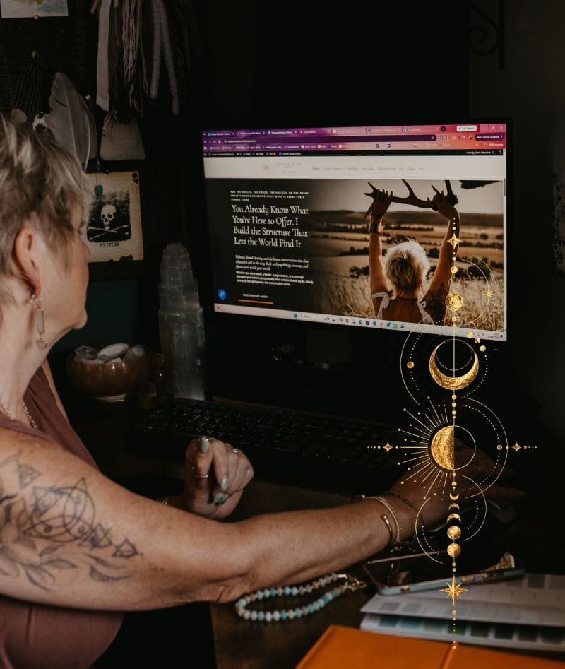 Tania Meacher working at her computer, reviewing a website design on the screen.